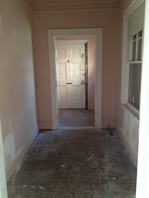 You are now standing outside those closet doors you saw in the first image. This is looking at the front door. The original tile is still in tact in the entry way. Then you get a door that closes to create a heat/cold barrier.