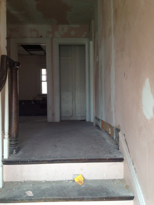 Landing at the top of the stairs. The door you see on the right is a closet; the door on the left is the bathroom. This will be reconfigured. 